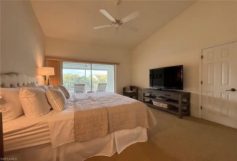 Bedroom featuring high vaulted ceiling, access to exterior, ceiling fan, and carpet floors