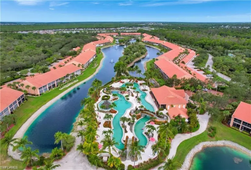 Birds eye view of property with a water view