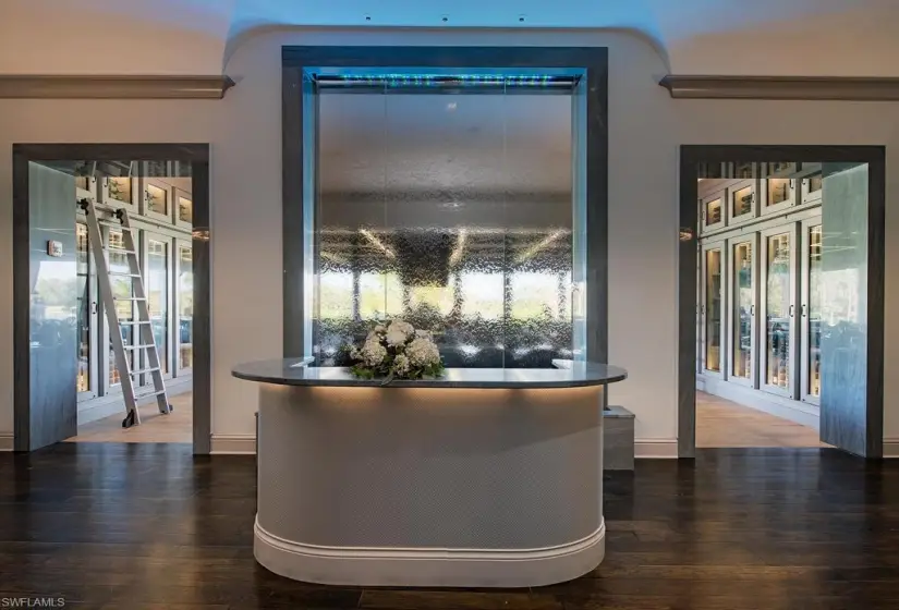 Bar featuring dark hardwood / wood-style floors