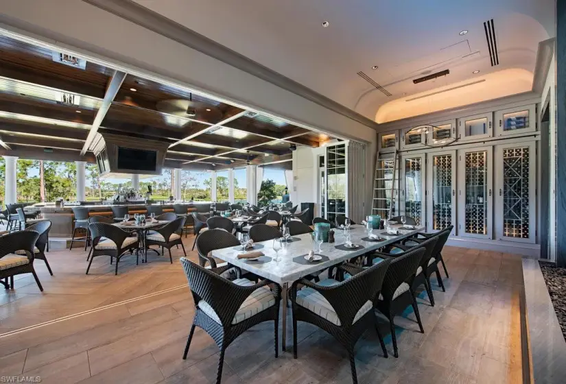 Dining room with a tray ceiling, coffered ceiling, and hardwood / wood-style floors