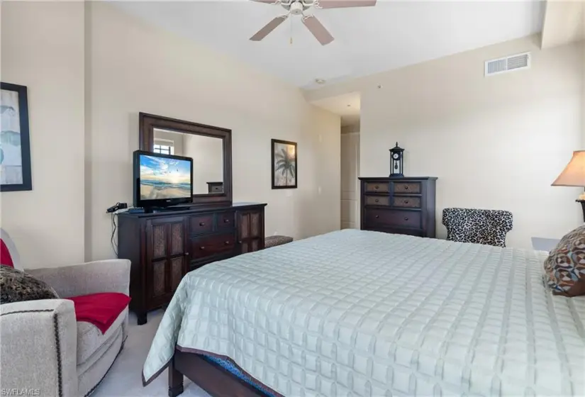 Carpeted bedroom with ceiling fan