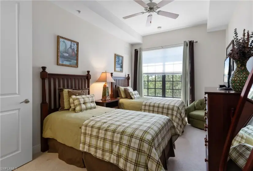 Carpeted bedroom featuring ceiling fan