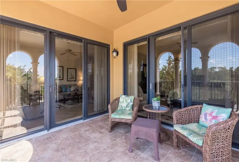 View of patio featuring ceiling fan and impact resistant windows