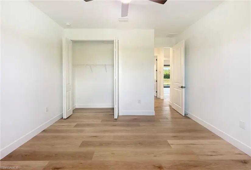 bedroom featuring a closet, ceiling fan, and light hardwood / wood-style flooring