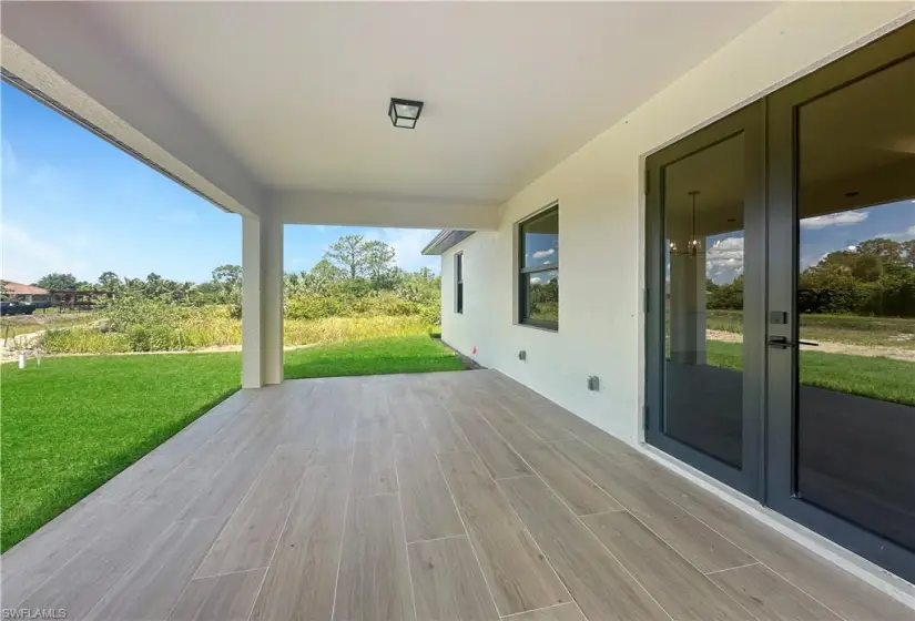 Deck featuring a lawn and a patio