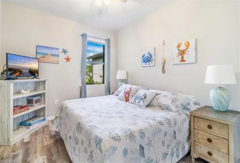 Bedroom with ceiling fan and hardwood / wood-style flooring