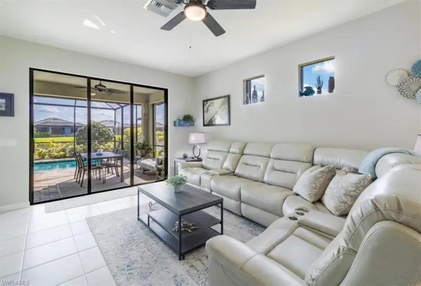 Tiled living room featuring ceiling fan