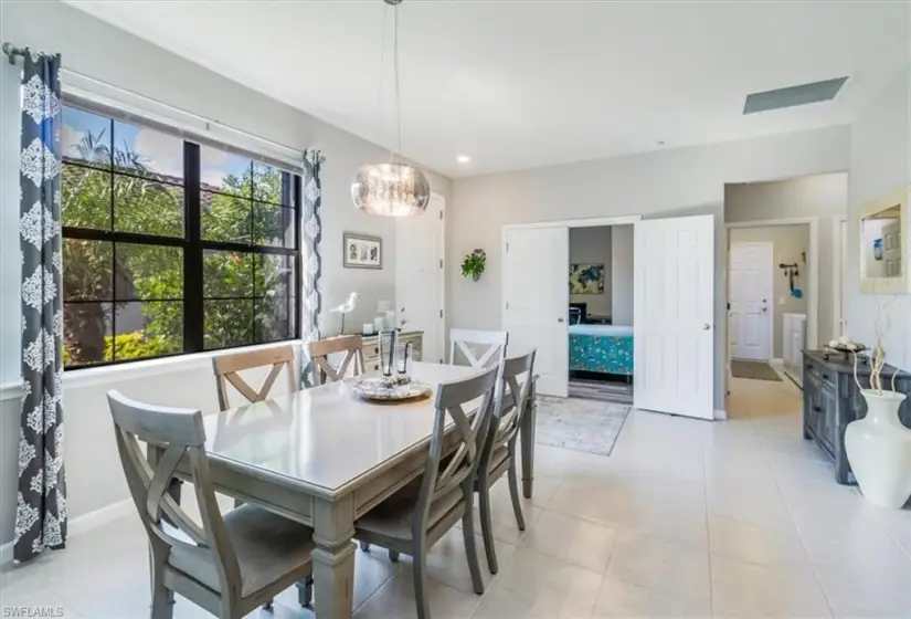 Tiled dining room featuring a notable chandelier